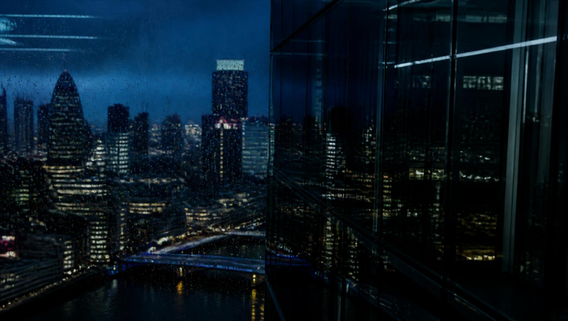 City business district at dusk, viewed through a high-rise window